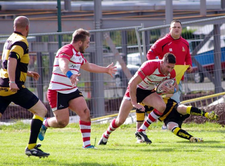 Lee Riley breaks a tackle as the full back scores for the Mariners